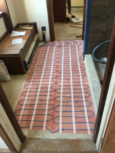 An underfloor heating mat being installed, a service provided by ELSI Electric LLC in Rockville, MD.