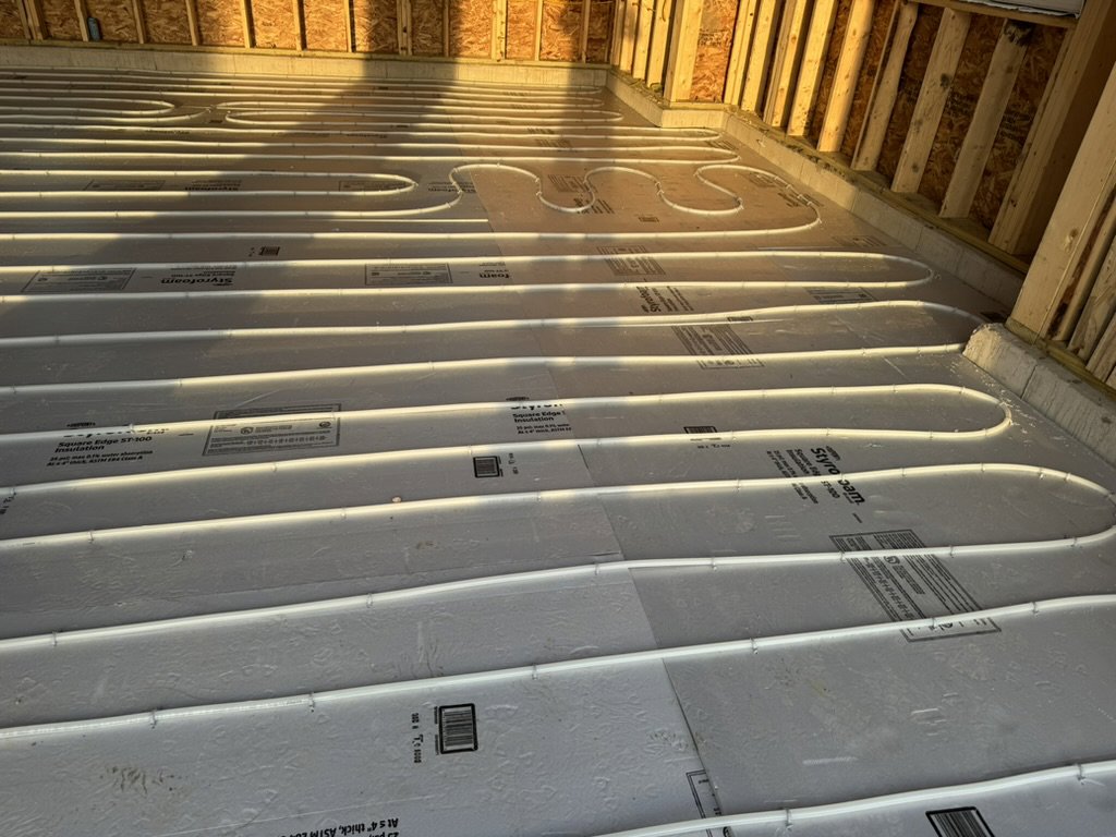 An underfloor radiant heating system with pipes laid out in a new construction project by Dischler Heating-Cooling & Fireplaces in Prairie du Sac, WI.