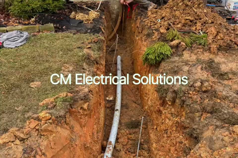 Underground electrical conduit installation in a trench by CM Electrical Solutions in Elizabethtown, KY.