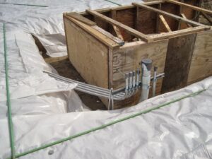 Underground electrical conduit installation with a wooden formwork at a job site by Argosy Electric, Inc. in Newport News, VA