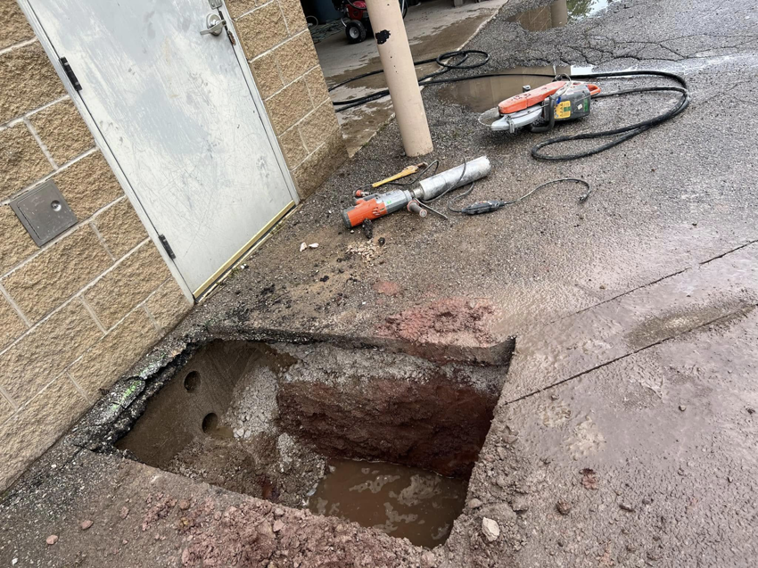 Underground electrical conduit installation in progress with tools and trench visible by Best Electric in Charleston, WV.