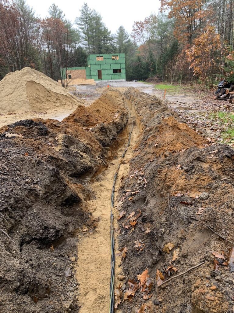 Underground electrical conduits and cables laid in a trench for new construction by Building Connections LLC in Auburn, ME.