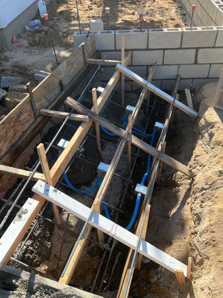 Underground electrical conduits and wiring laid in a foundation trench by Gilmore Electrical in Saint Louis, MO