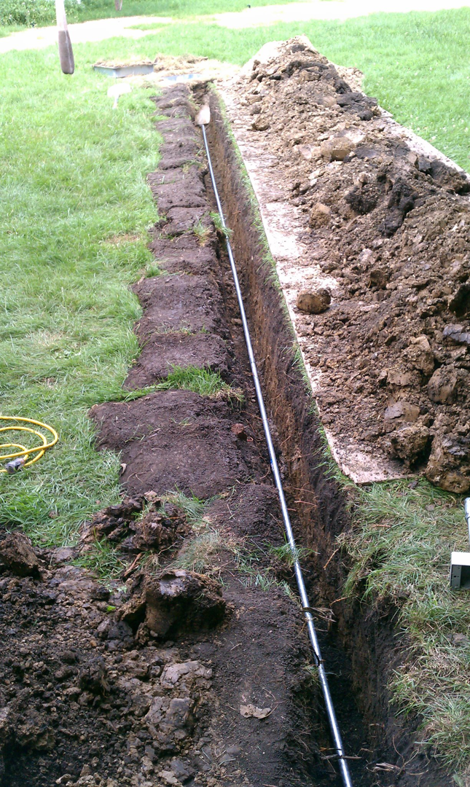 Underground electrical conduit being installed in a trench by Hunsicker Electrical Services in Chicago, IL.