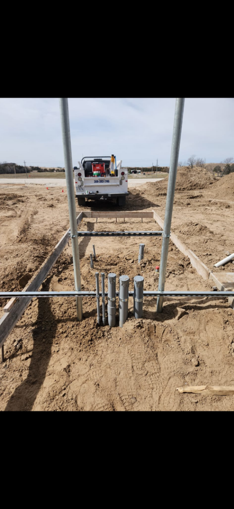 Underground electrical conduits being installed in a trench for a new project by Island Electric in Grand Island, NE.
