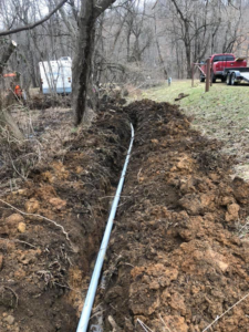 Underground electrical conduit installation in a trench by Jon Chamberlain Electrical Services in Saxton, PA.