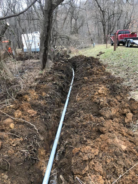 Underground electrical conduit installation in a trench by Jon Chamberlain Electrical Services in Saxton, PA.