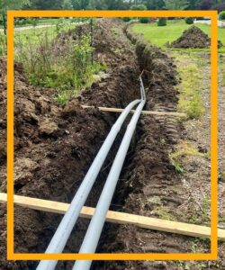 Underground electrical conduit installation in a trench by Pinnacle Electric Solutions in Port St. Lucie, FL.