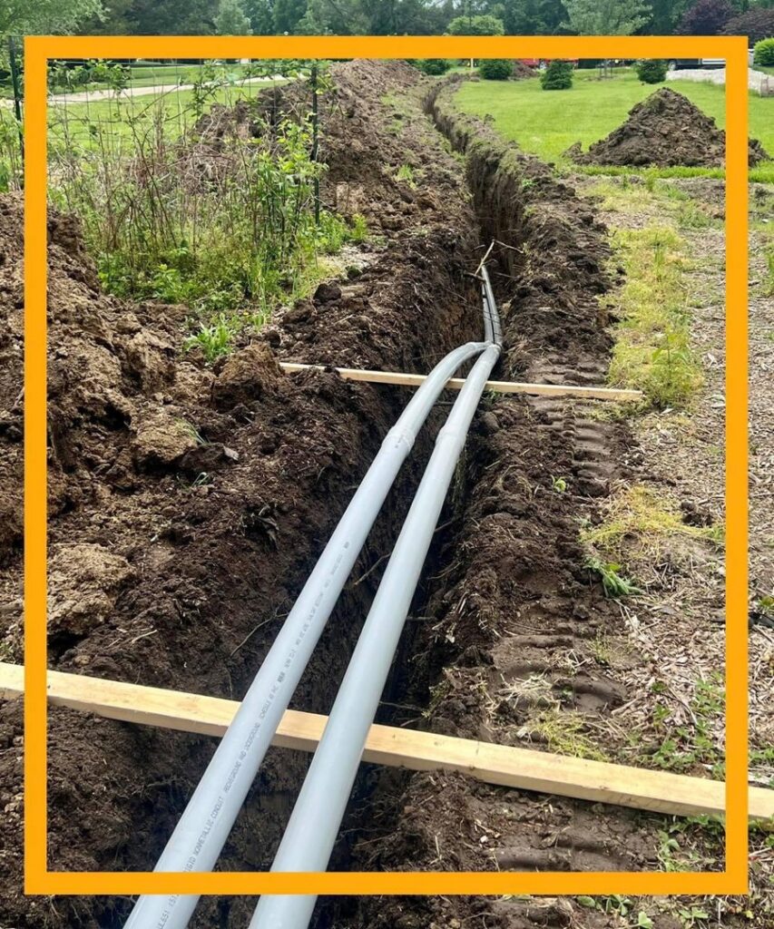 Underground electrical conduit installation in a trench by Pinnacle Electric Solutions in Port St. Lucie, FL.