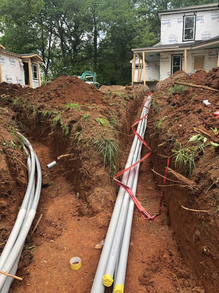 Underground electrical conduits being installed in a trench for a new construction project by TCB Electric LLC in Elizabethtown, KY.