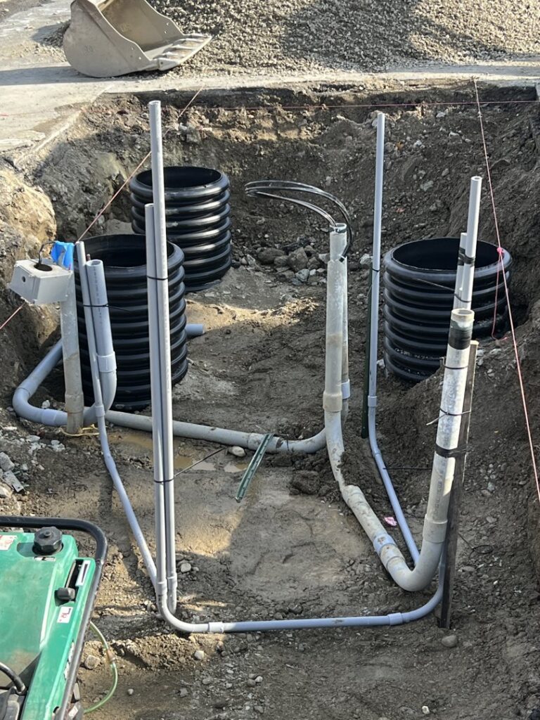An extensive underground electrical conduit system being installed in an excavated trench by Peeler Electric Light & Power in Merrimack, NH.