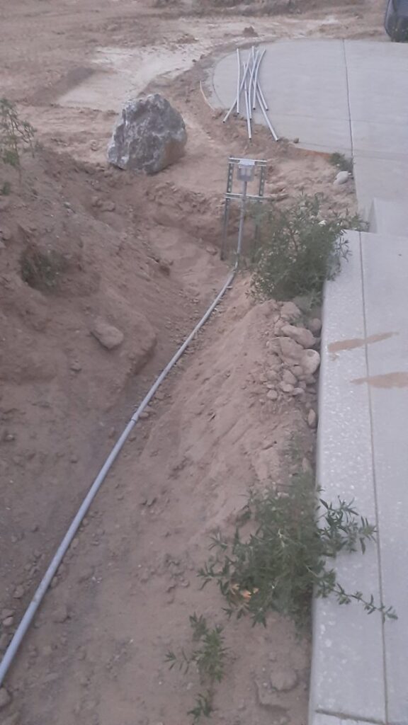 Underground electrical conduit laid in a trench during an installation project by Ostberg Electrical Solutions in Idaho Falls, ID.