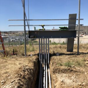 Underground electrical conduits being installed in a trench leading to an electrical panel structure by Rush Electric Memphis, TN.