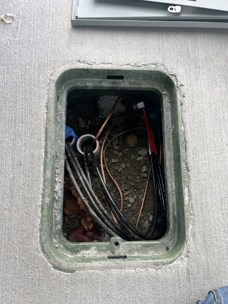 Underground electrical connections and wiring in an open utility box, serviced by Peeler Electric Light & Power in Merrimack, NH.