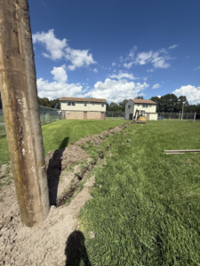 A trench dug for underground electrical wiring next to a utility pole by Relay Electric, LLC in Suffolk, VA.