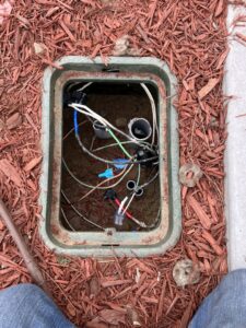 Underground electrical wiring and connections in an open utility box, serviced by Peeler Electric Light & Power in Merrimack, NH.