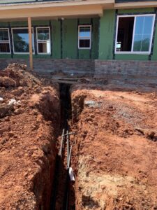 Underground piping for an HVAC system installation at a construction site by Trinity Climate Control in Clayton, NC.
