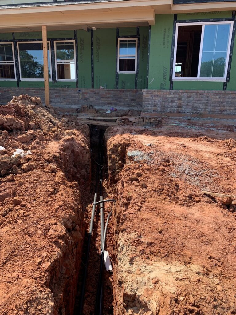 Underground piping for an HVAC system installation at a construction site by Trinity Climate Control in Clayton, NC.