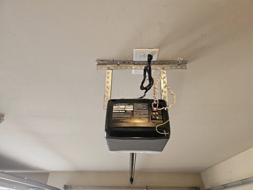 Underside view of a garage door opener showing wiring and mounting by Total Door Solutions in Yukon, OK