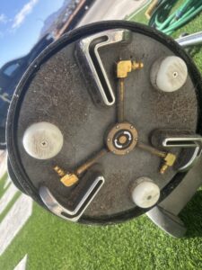 A close-up view of the underside of a carpet cleaning machine, showing accumulated dirt and fibers from a job by El Paso Carpet Care in El Paso, TX.