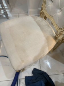 An upholstered chair showing a clear before and after cleaning result by White Diamond Carpet Cleaners in Baton Rouge, LA.