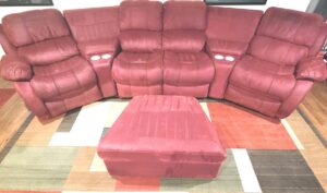 A red sectional sofa and ottoman showing cleaning lines after professional upholstery and rug cleaning by Belles Carpet Cleaning & Janitorial Inc. in Harrisburg, PA.