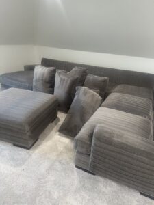 A grey sectional sofa on a clean carpet, indicating upholstery and carpet cleaning by Jake's Steamer the Carpet Cleaner in Seminole, TX
