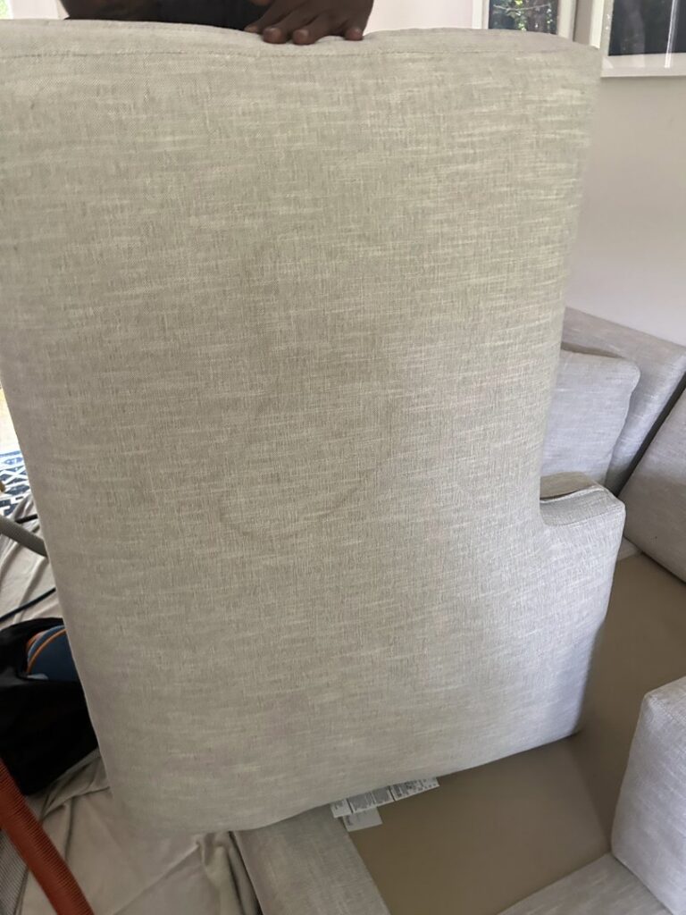 An upholstered chair back showing a stain, ready for cleaning by Treo General Services of North Carolina LLC in Durham, NC.