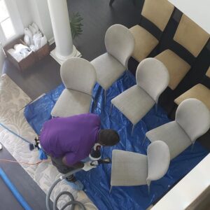 An overhead view of a professional cleaning upholstered chairs by Treo General Services of North Carolina LLC in Durham, NC.