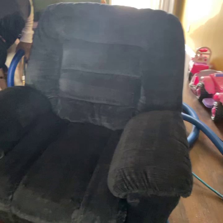 A black recliner being professionally cleaned, showing the cleaning process by Iclean Indy in Indianapolis, IN.