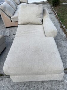 A light-colored chaise lounge being cleaned outdoors, demonstrating upholstery cleaning by Just Right Carpet Cleaning of Goose creek moncks corner in North Charleston, SC.