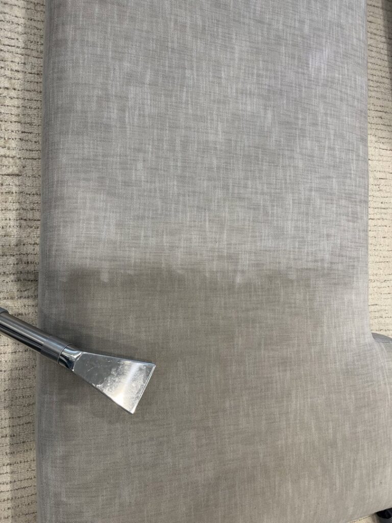 Upholstery being cleaned with a specialized tool, showing a clean strip by Veterans Chem-Dry Music City in Nashville, TN.