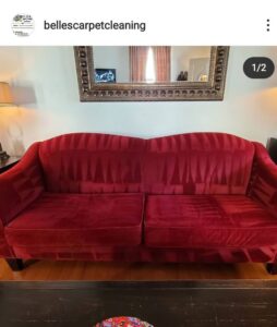 A red sofa showing distinct cleaning lines after professional upholstery cleaning by Belles Carpet Cleaning & Janitorial Inc. in Harrisburg, PA.