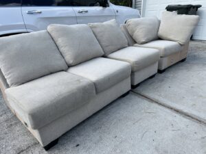 Sectional sofa pieces being cleaned outdoors, showing upholstery cleaning services by Just Right Carpet Cleaning of Goose creek moncks corner in North Charleston, SC.