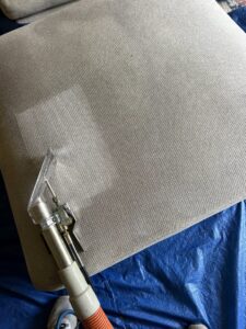 Upholstery cleaning service in progress on a sofa cushion by Arise Carpet Cleaning in Kailua, HI.
