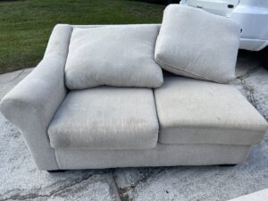 A light-colored sofa being cleaned outdoors, showcasing upholstery cleaning services by Just Right Carpet Cleaning of Goose creek moncks corner in North Charleston, SC.