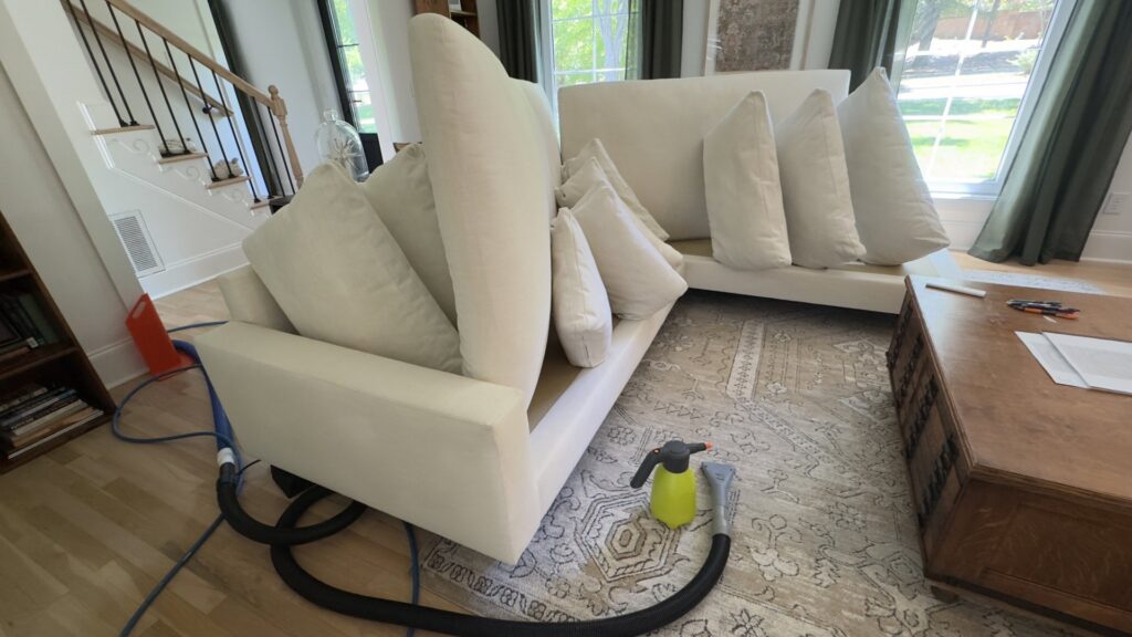 Upholstery cleaning in progress on a sofa with cushions removed by Pronto And Carpet LLC in Charlotte, NC.