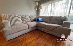 A sectional sofa being dried with air movers after upholstery cleaning by Rent A Vet Carpet Cleaning in St. Charles, MO.