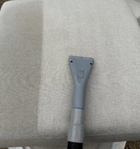 An upholstery cleaning tool being used on furniture by Great Day Carpet & Tile Cleaning LLC Desoto in Olive Branch, MS.
