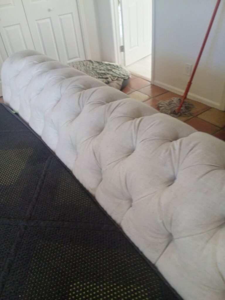 Professional upholstery cleaning of a long, tufted bench or sofa by Carpets Dirty in Phoenix, AZ