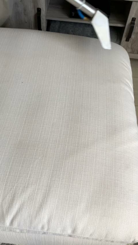 A close-up view of a white upholstered cushion being professionally cleaned by Chem-Dry Nona in Orlando, FL.