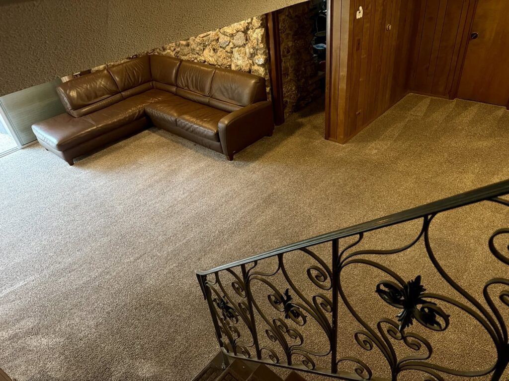 A close-up of an upholstery cushion showing cleaning lines from a professional service by Proper Carpet Cleaning in Aurora, IL.