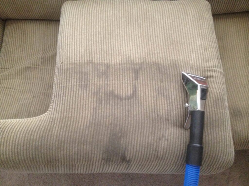 An upholstery cleaning tool actively cleaning a dirty sofa cushion for Ecodry Carpet Cleaning Las Vegas, NV.