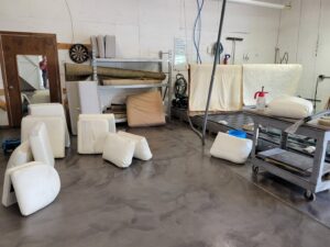 Upholstery cushions and rolled rugs in a storage area, ready for cleaning or after cleaning by KODA Carpet Cleaning in Holland, MI.