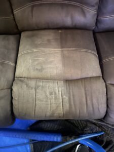 Before and after view of a sofa cushion being cleaned by Brooke's Chem-Dry Lawrence in Kansas City, MO, showing dirt removal.