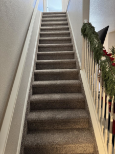 View of an upstairs carpeted staircase, expertly installed by Cruz Carpet / Vidal Cruz in Colorado Springs, CO