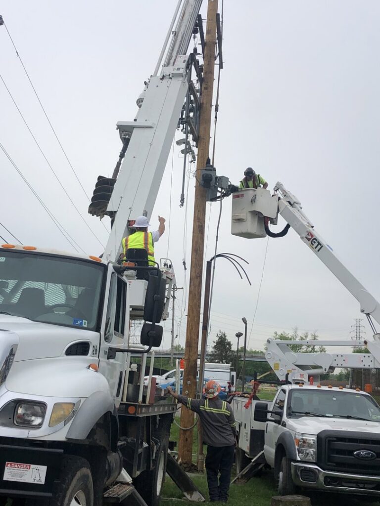 Utility electricians working on power lines and a utility pole from bucket trucks for Pro 1 Electric, Inc. in Parkersburg, WV