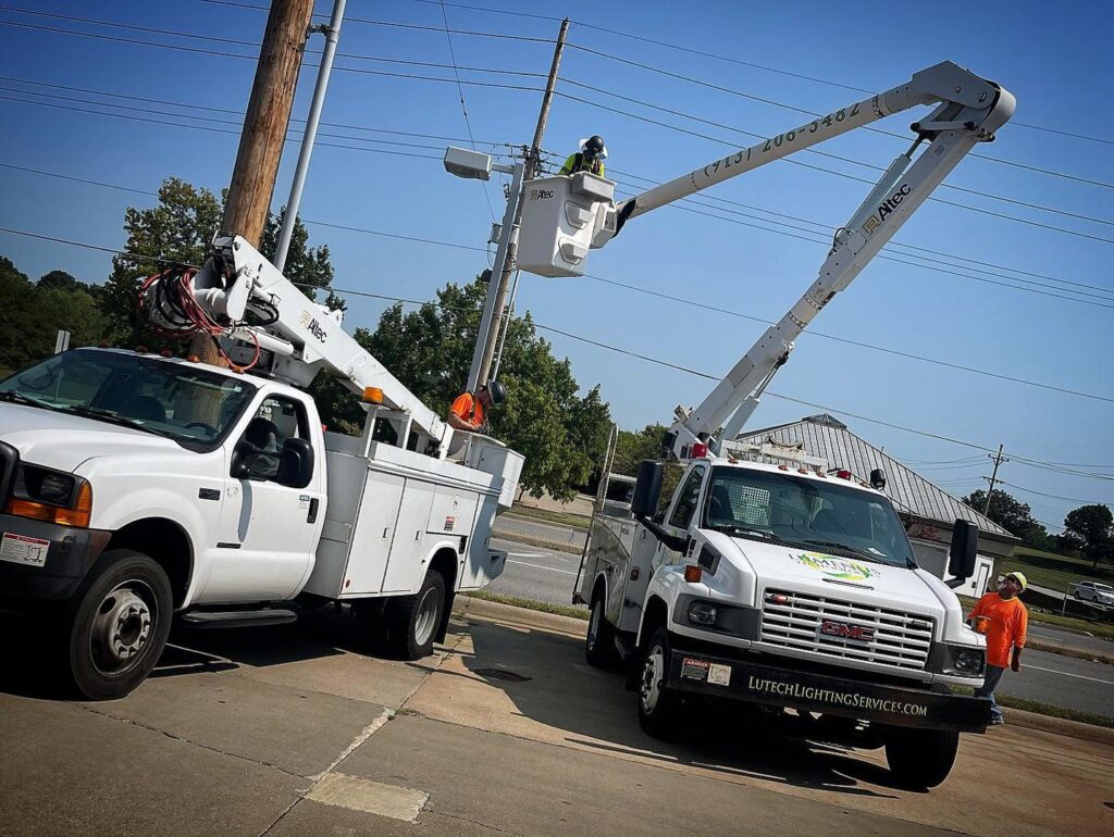 Lumenus Technologies, LLC electricians performing electrical work on a utility pole in Lenexa, KS.