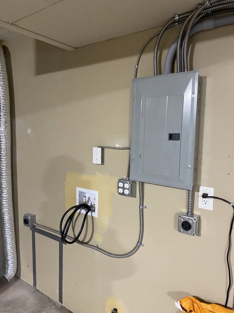 An electrical panel, outlets, and conduit in a utility room installed by Good Contact Electric, LLC in Tacoma, WA.