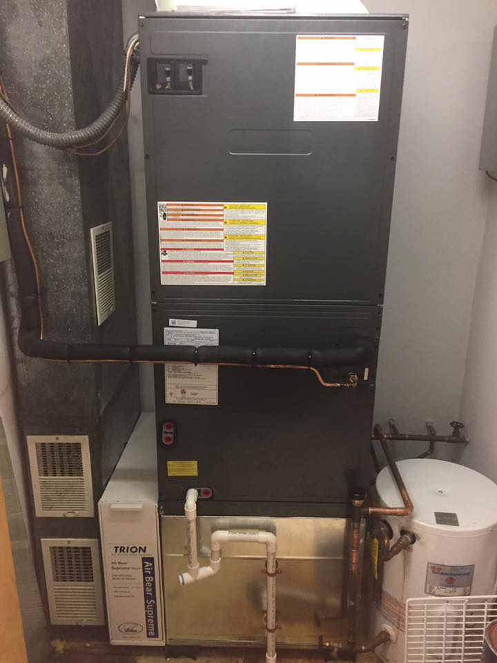 A furnace, ductwork, and water heater installed in a utility room by R&M Mechanical Services LLC in Londonderry, NH